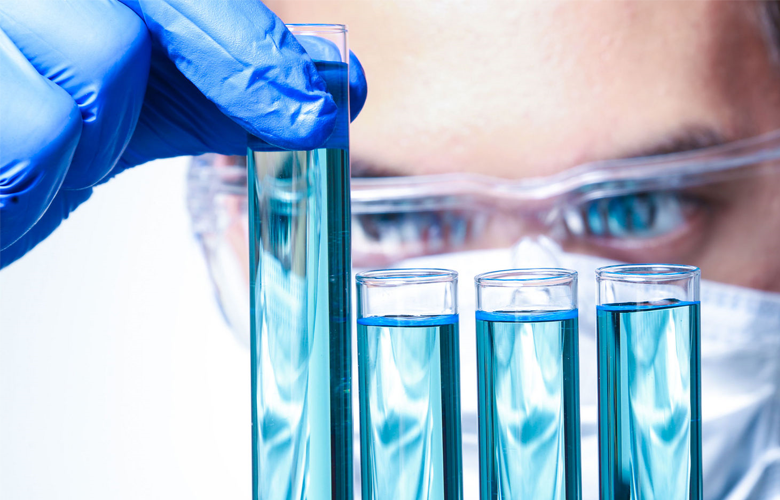 photo of a scientist looking at vials